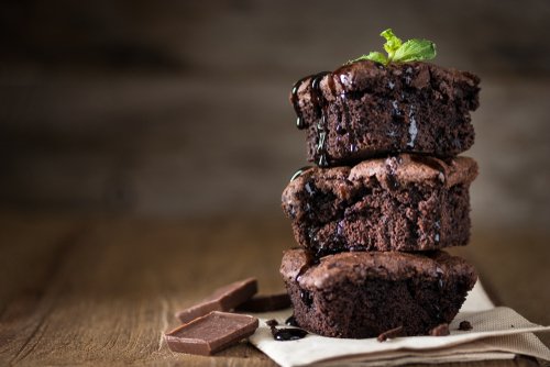 A,Stack,Of,Chocolate,Brownies,On,Wooden,Background,With,Mint